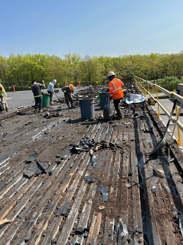A group of people working on the roof of a building.